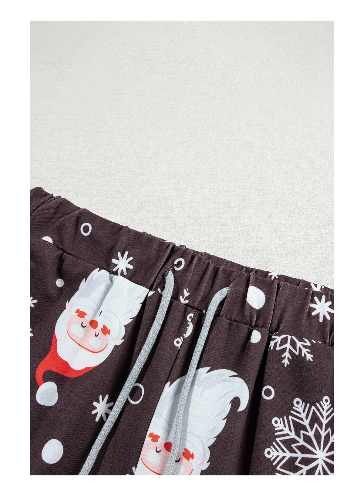 White Christmas pajama set featuring Santa Claus print on shirt and pants, perfect for holiday celebrations.