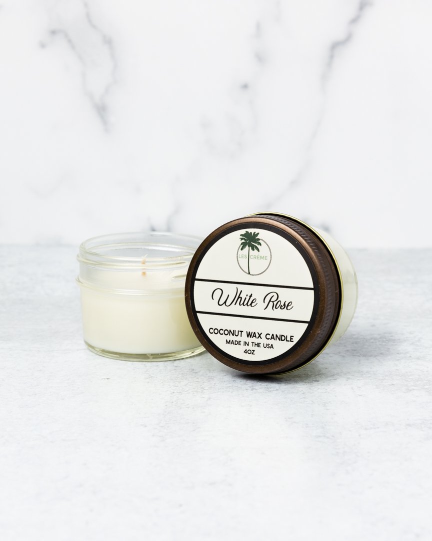 A beautifully crafted White Rose Scent Coconut Wax Candle in a glass jar, showcasing its elegant design and natural ingredients.