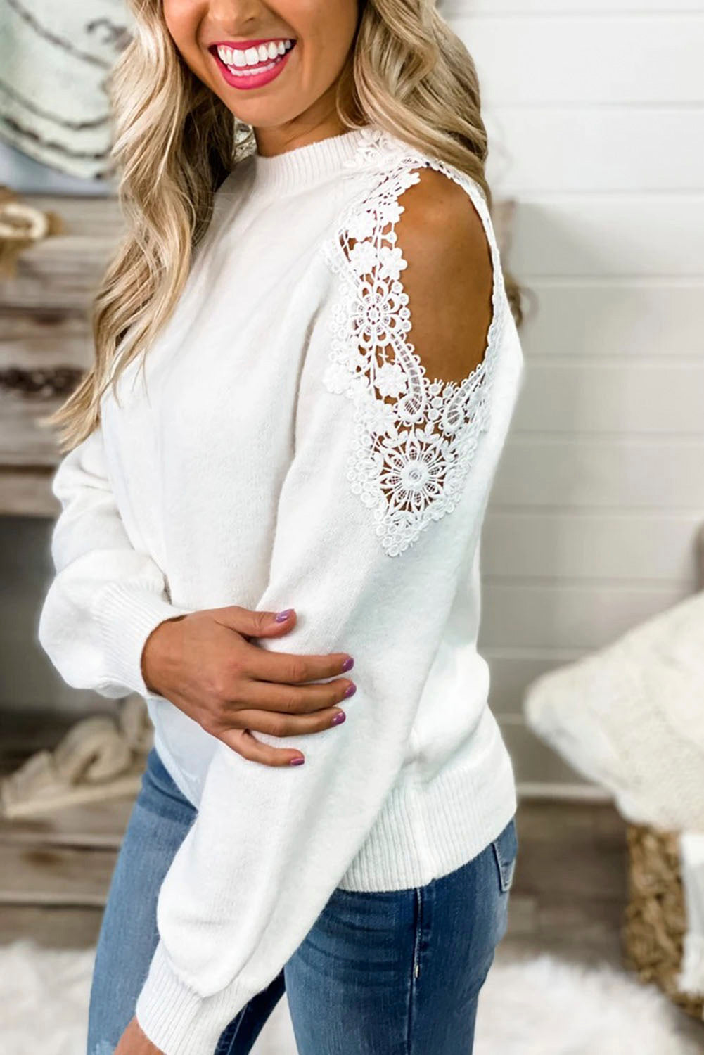 A stylish white round neck sweater featuring cold shoulder design and delicate lace splicing, perfect for chic casual wear.