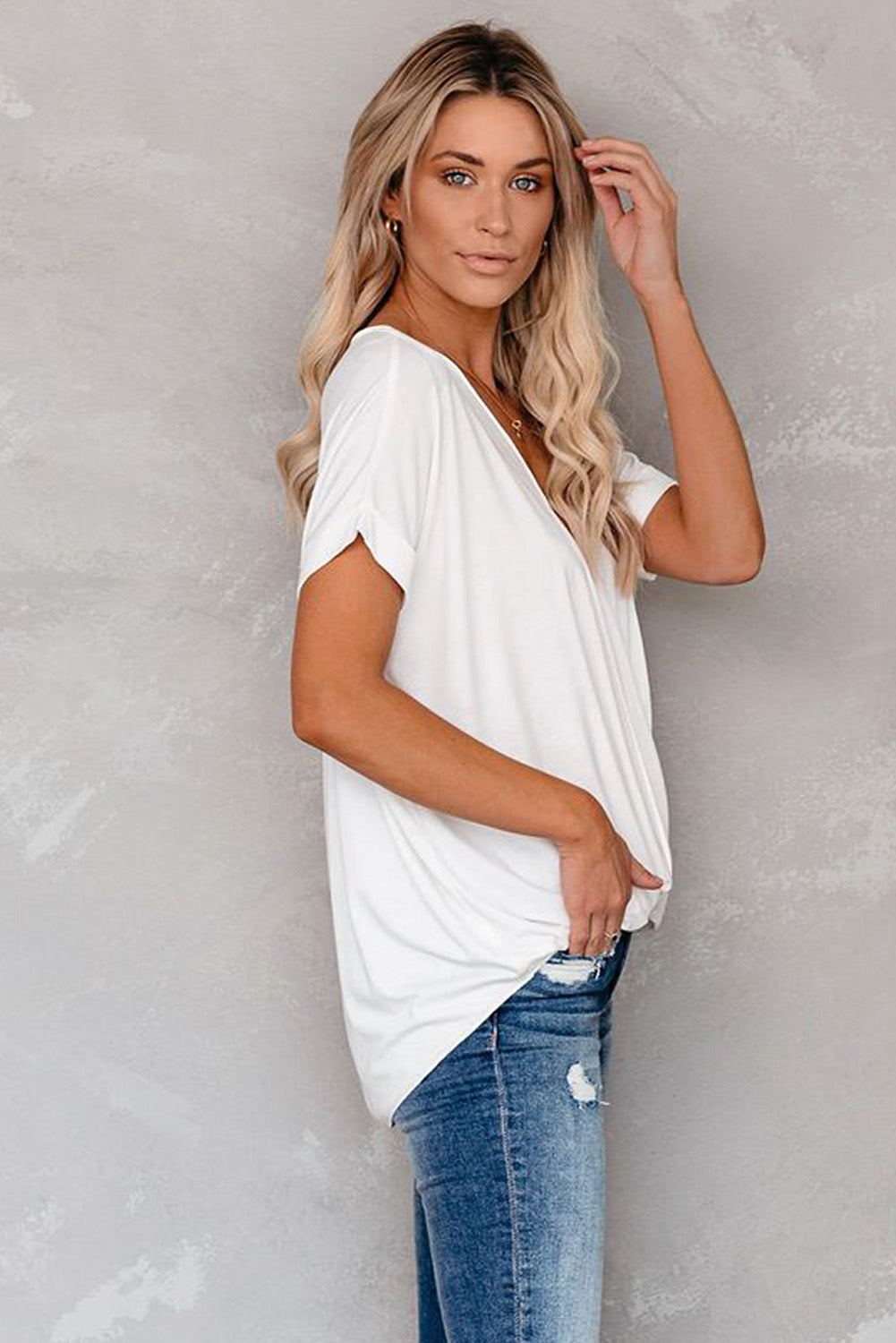 White short sleeves drape knit top with v-neckline and cuffed sleeves, showcasing a chic hi-lo hem design.