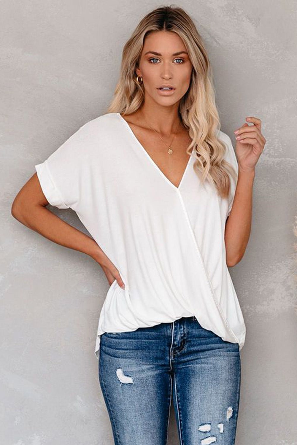 White short sleeves drape knit top with v-neckline and cuffed sleeves, showcasing a chic hi-lo hem design.