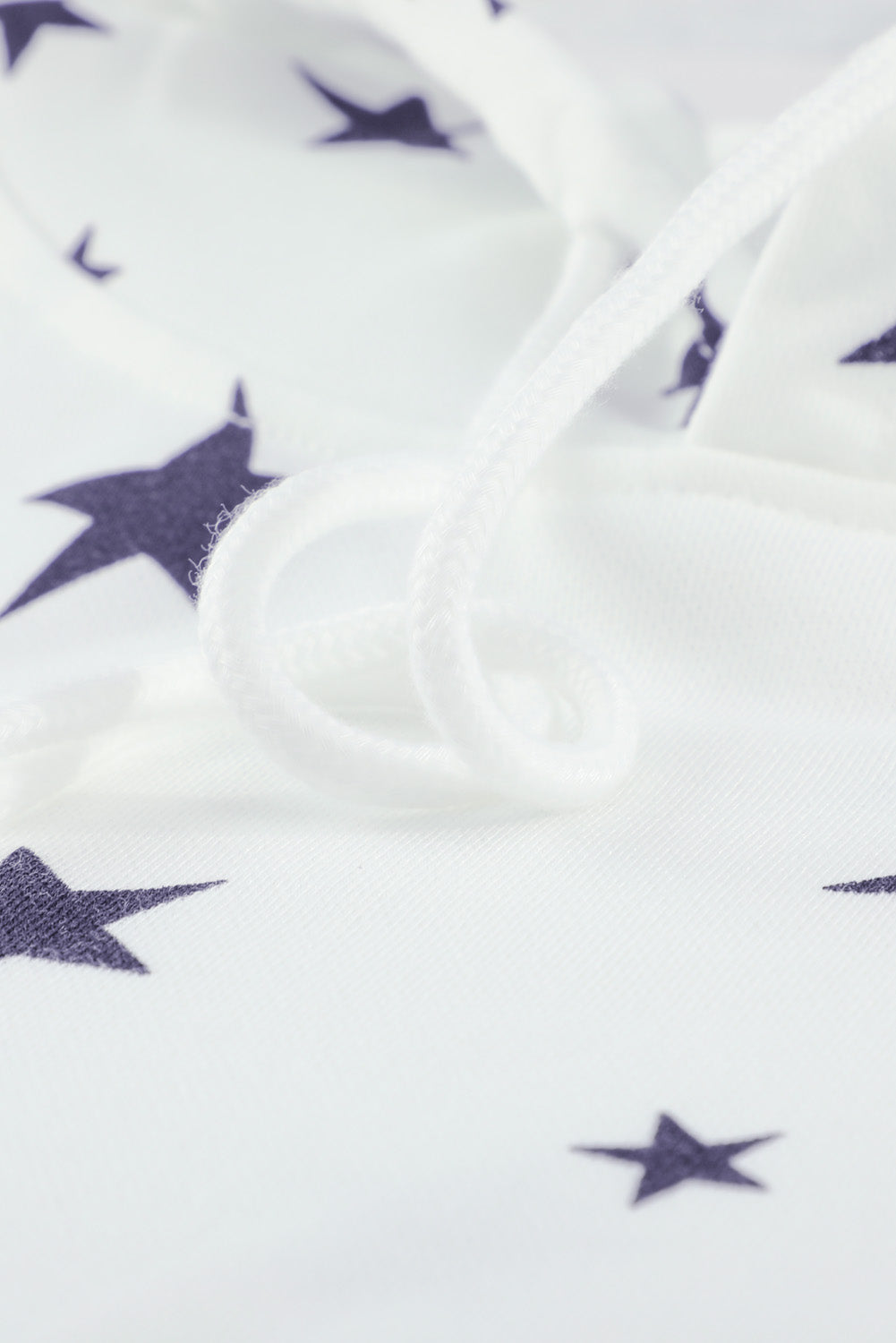 A stylish white hoodie featuring a star print design and side slits, perfect for casual wear.