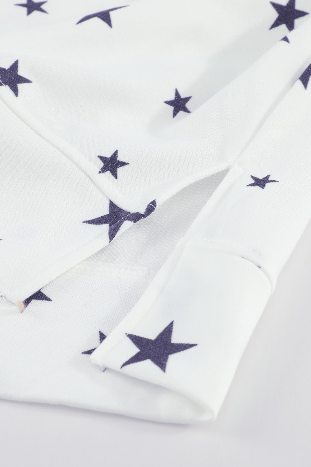 A stylish white hoodie featuring a star print design and side slits, perfect for casual wear.