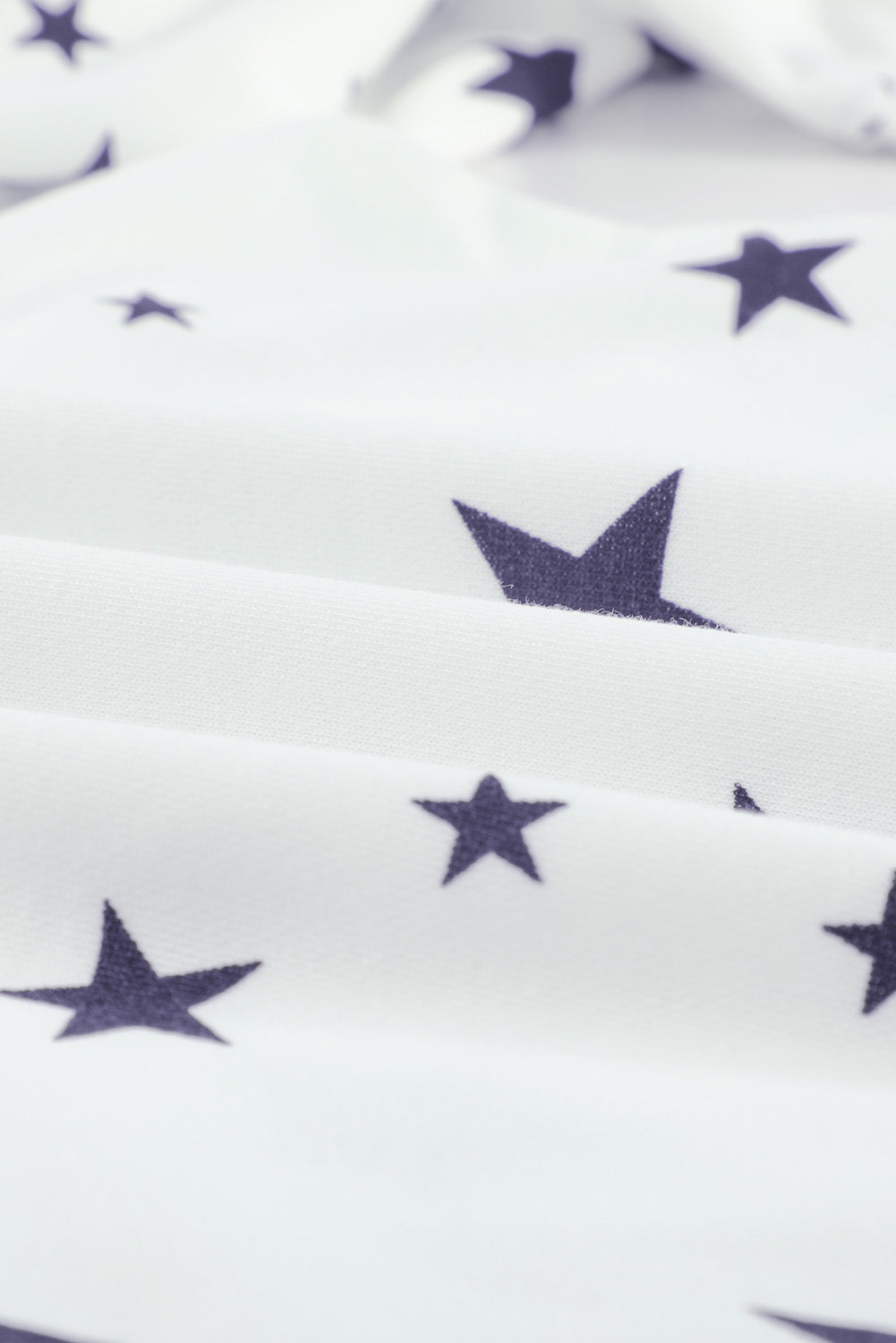 A stylish white hoodie featuring a star print design and side slits, perfect for casual wear.