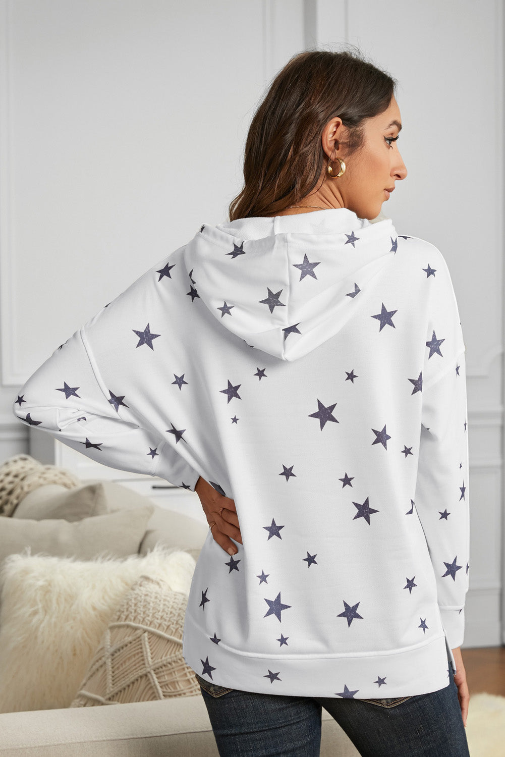 A stylish white hoodie featuring a star print design and side slits, perfect for casual wear.