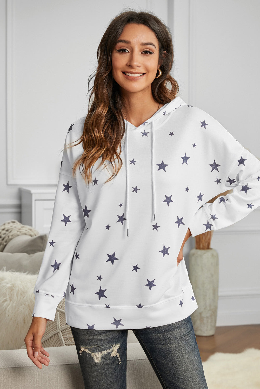 A stylish white hoodie featuring a star print design and side slits, perfect for casual wear.