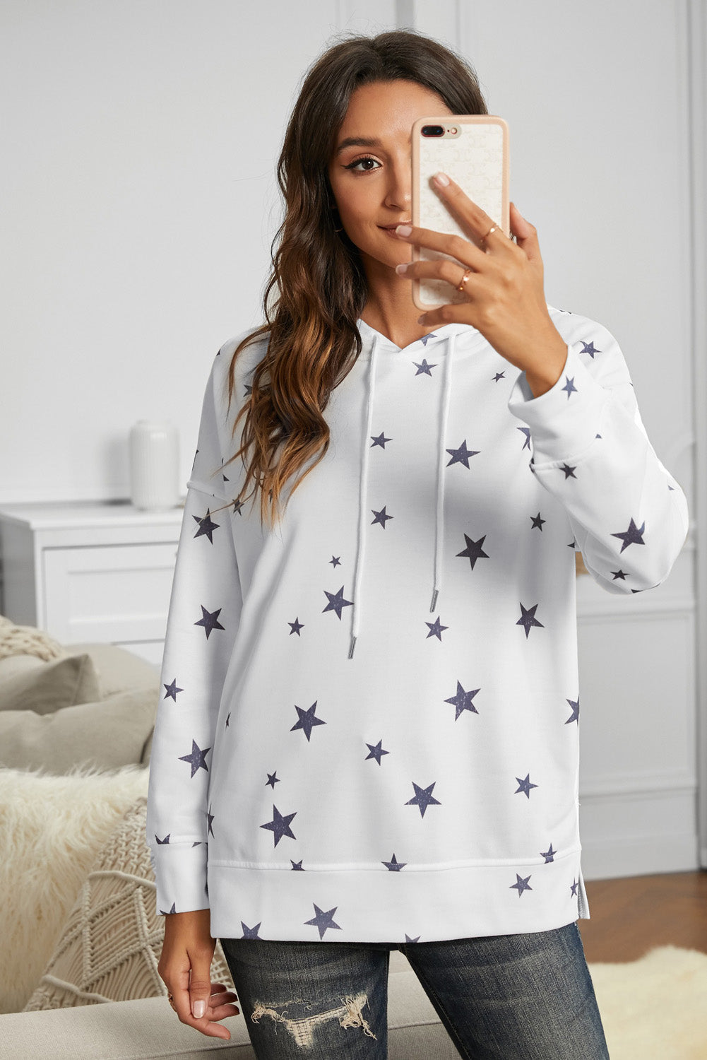 A stylish white hoodie featuring a star print design and side slits, perfect for casual wear.