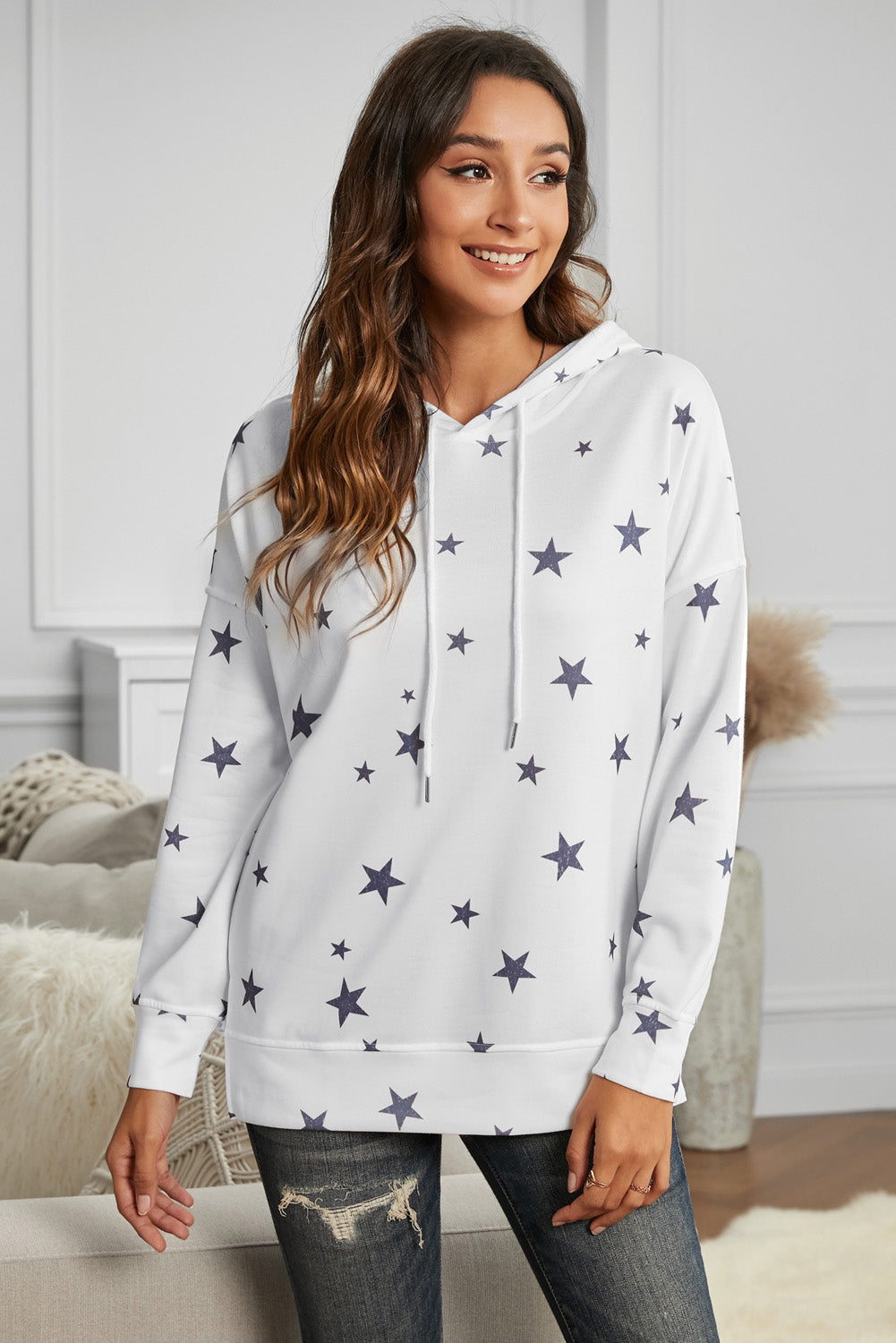 A stylish white hoodie featuring a star print design and side slits, perfect for casual wear.