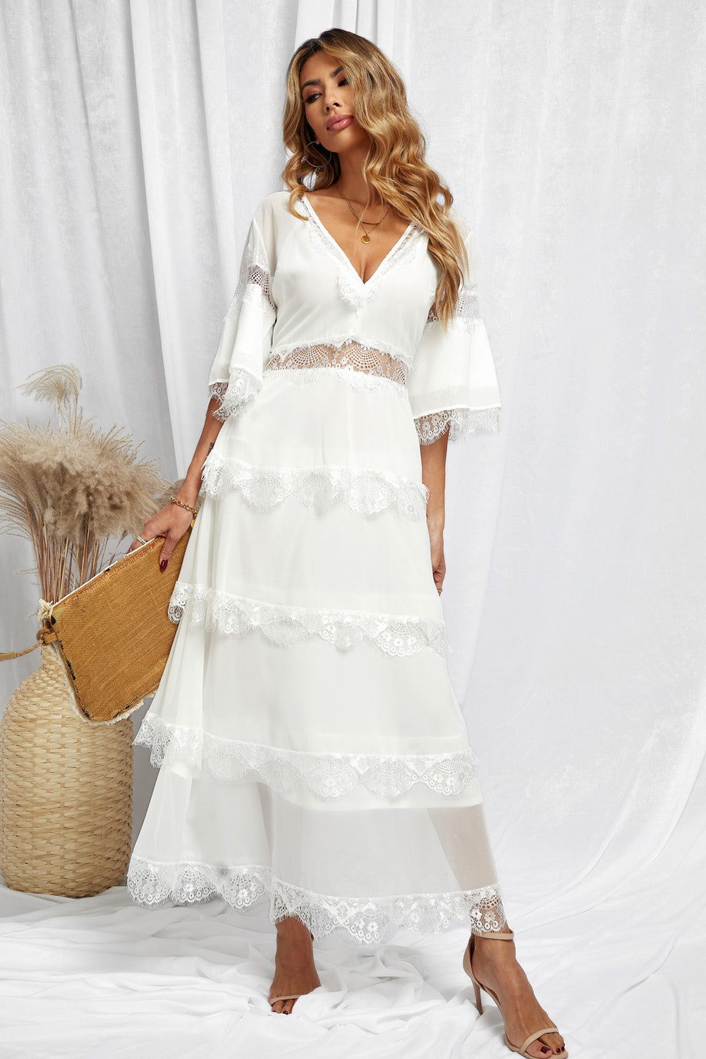 A beautiful White Swiss Dot Print See-through Lace Patch Layered Long Dress displayed elegantly, showcasing its delicate lace details and flowing silhouette.