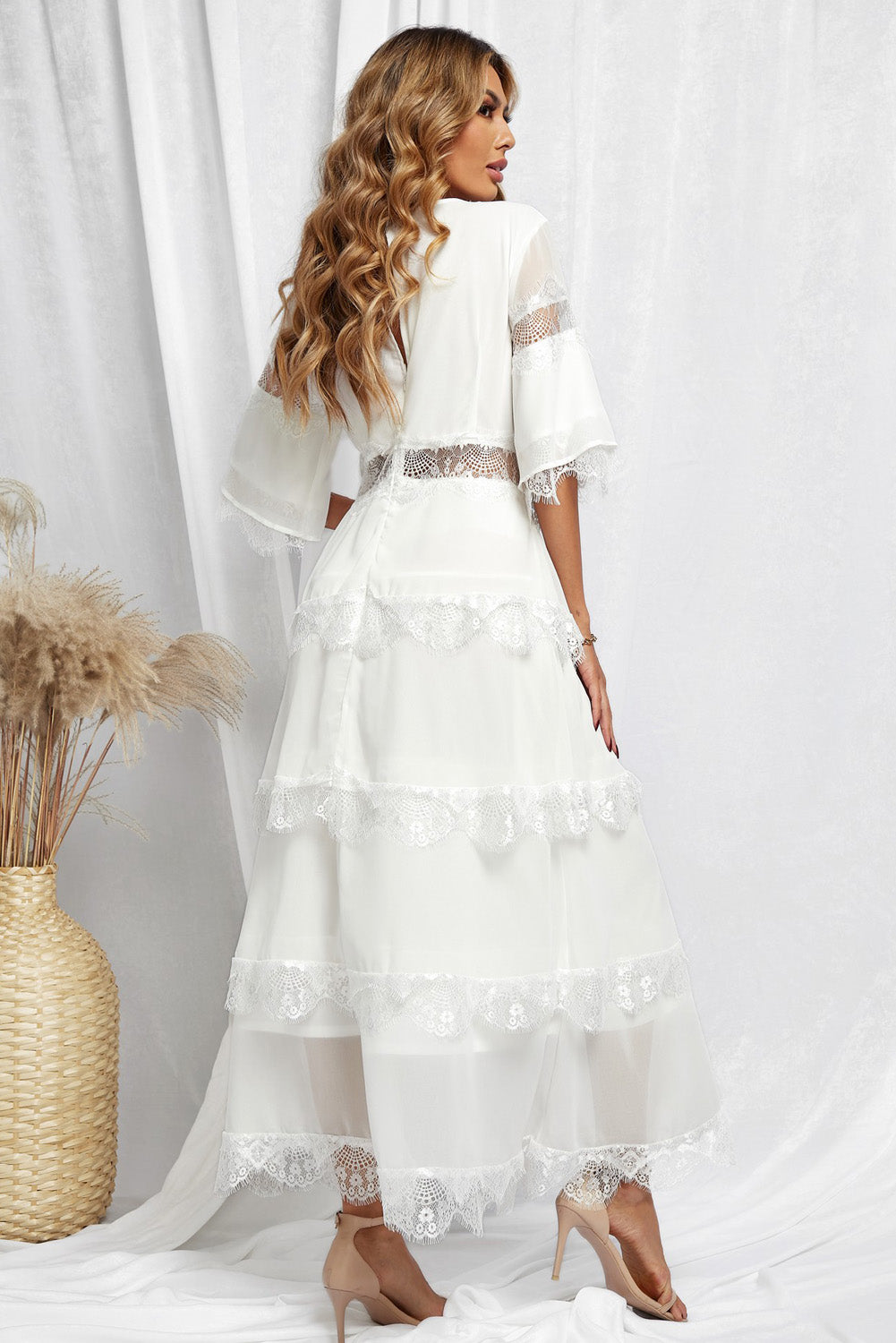 A beautiful White Swiss Dot Print See-through Lace Patch Layered Long Dress displayed elegantly, showcasing its delicate lace details and flowing silhouette.