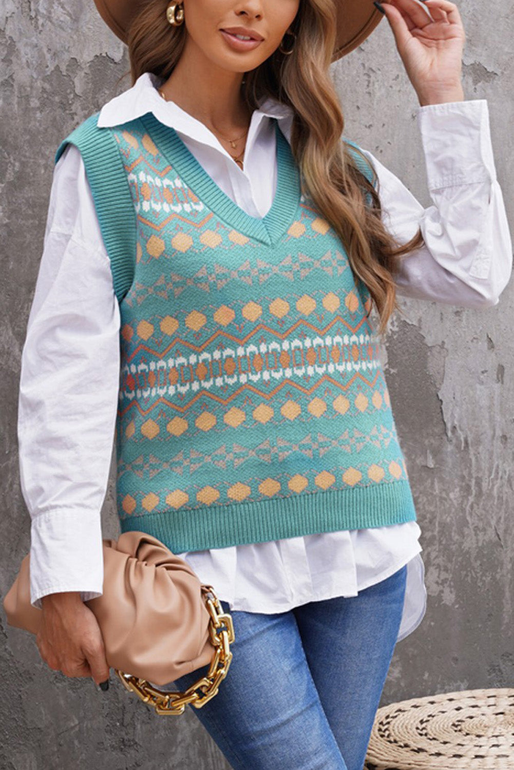 A stylish white knitted sweater vest featuring a unique tribal print design, perfect for layering during colder months.