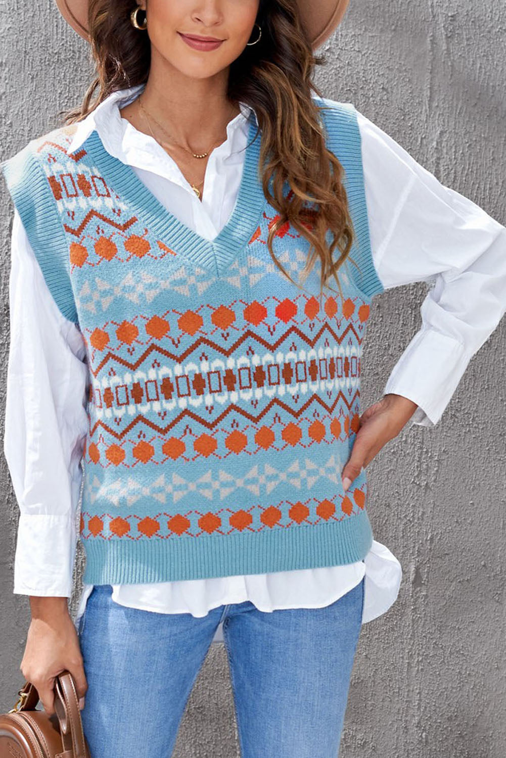 A stylish white knitted sweater vest featuring a unique tribal print design, perfect for layering during colder months.