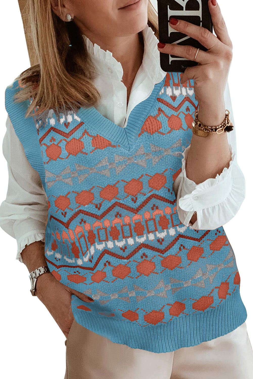 A stylish white knitted sweater vest featuring a unique tribal print design, perfect for layering during colder months.