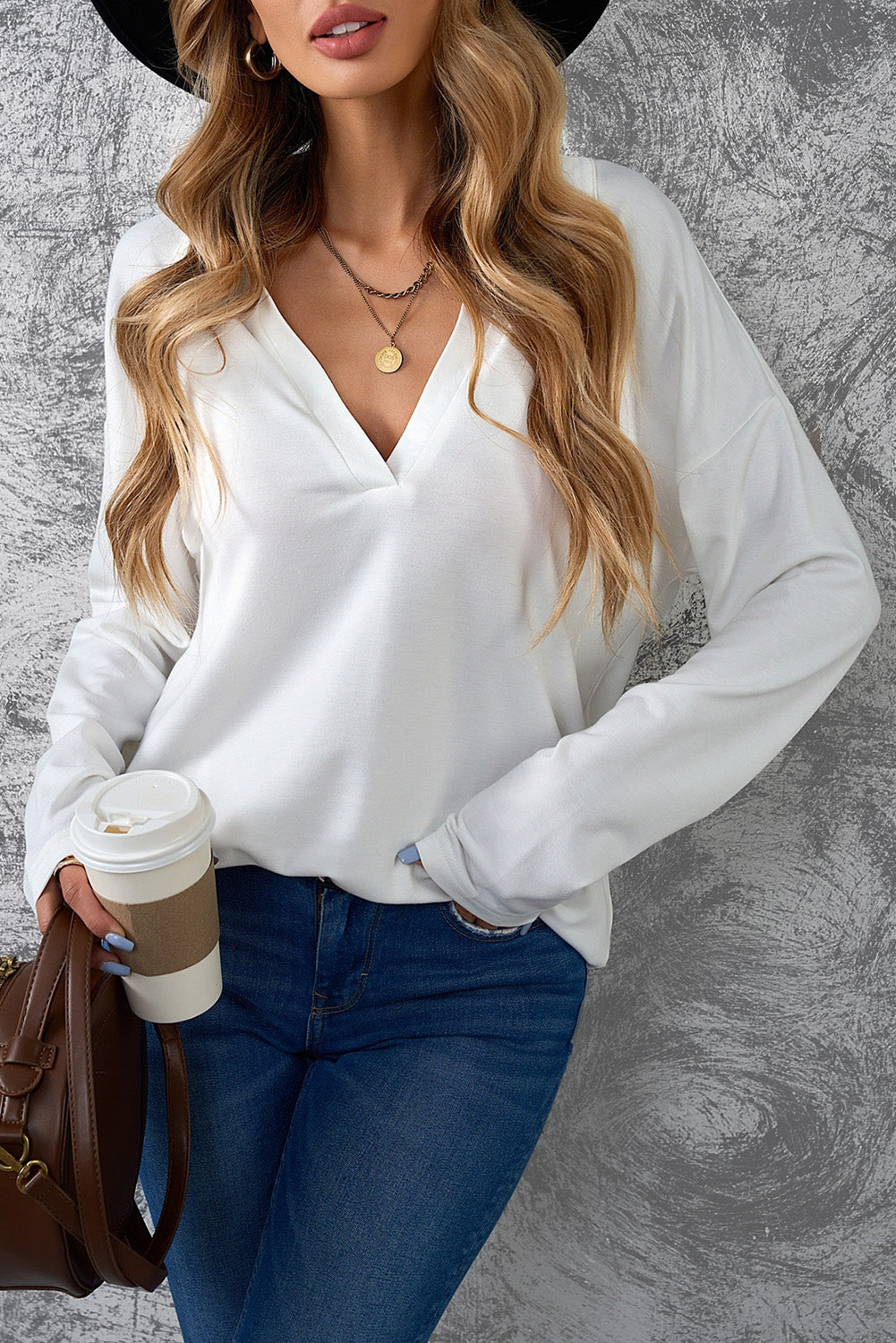 A stylish white turn-down V neck long sleeve top displayed on a mannequin, showcasing its elegant design and comfortable fabric.