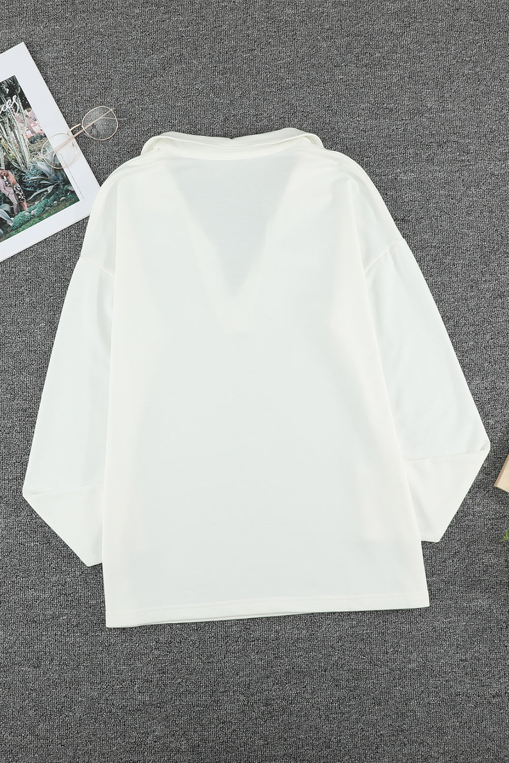 A stylish white turn-down V neck long sleeve top displayed on a mannequin, showcasing its elegant design and comfortable fabric.