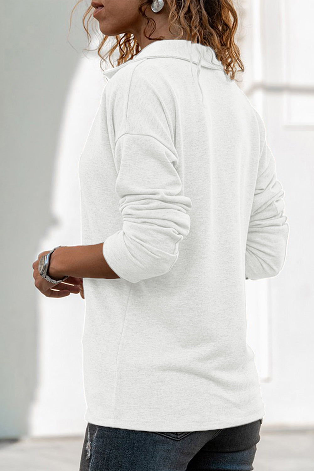 A stylish white turn-down V neck long sleeve top displayed on a mannequin, showcasing its elegant design and comfortable fabric.