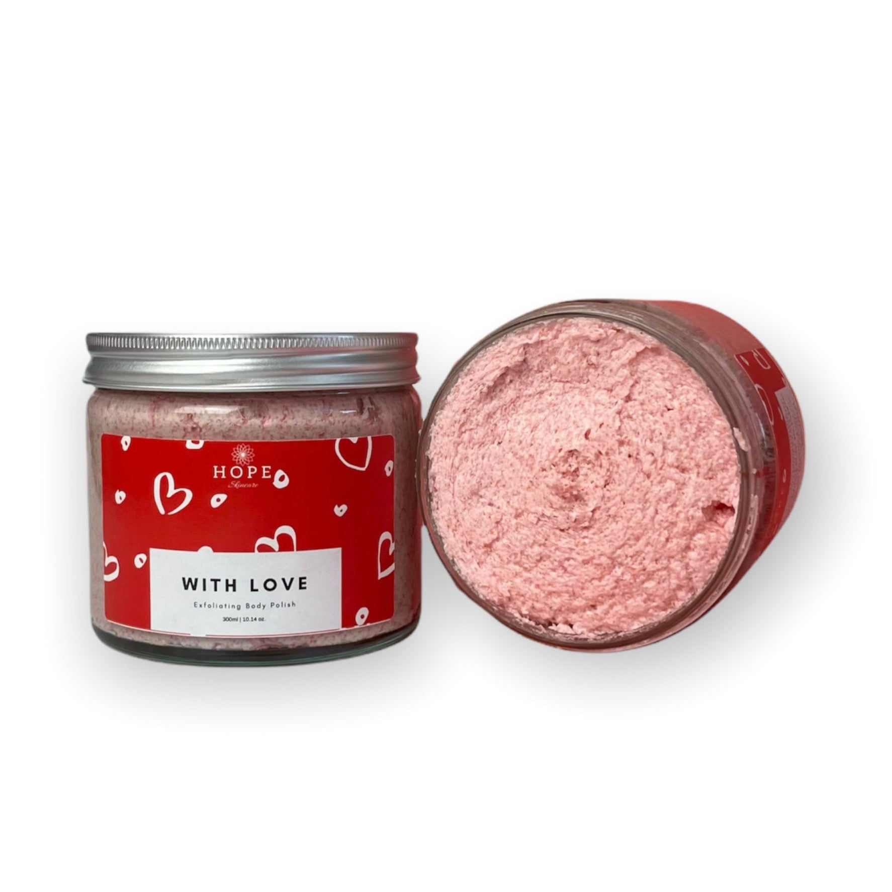 With Love Exfoliating Body Polish in a jar, featuring a creamy texture with visible strawberry pieces and a vanilla scent.