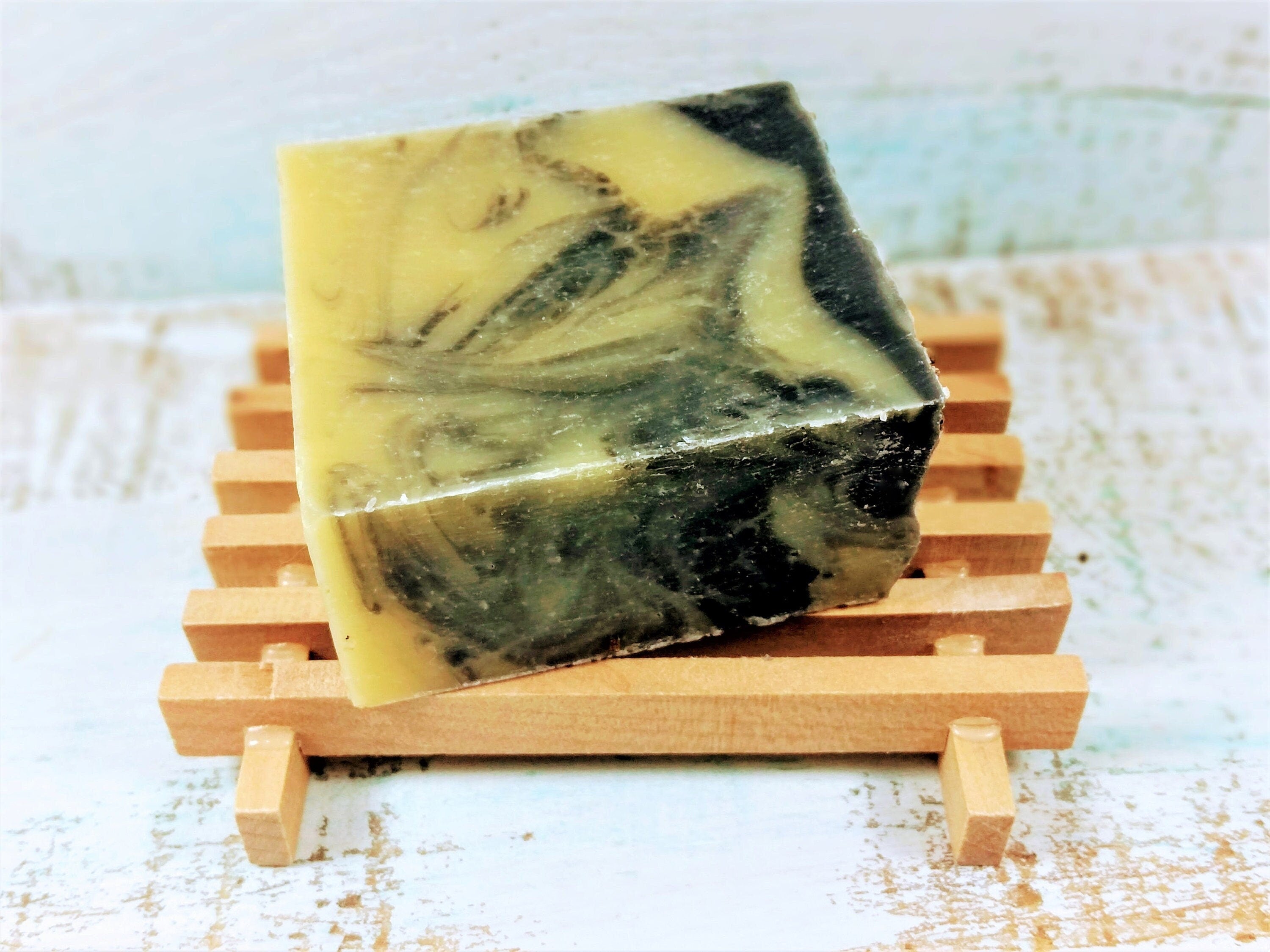 A stylish wooden soap dish designed for drying handmade soaps, featuring a natural wood finish and compact dimensions.