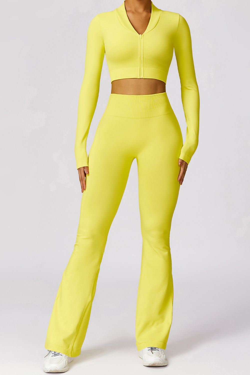 A vibrant yellow long sleeve crop top paired with stylish flare pants, perfect for workouts and casual wear.