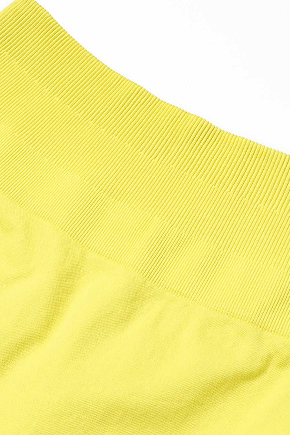 A vibrant yellow long sleeve crop top paired with stylish flare pants, perfect for workouts and casual wear.