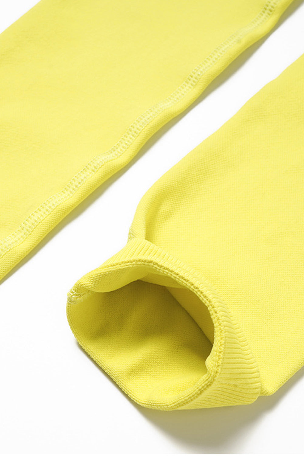 A vibrant yellow long sleeve crop top paired with stylish flare pants, perfect for workouts and casual wear.