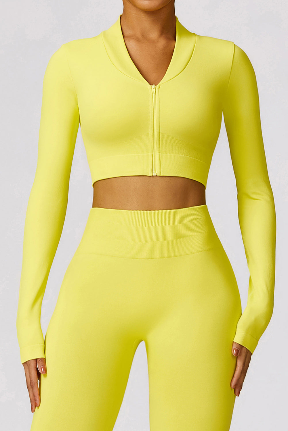 A vibrant yellow long sleeve crop top paired with stylish flare pants, perfect for workouts and casual wear.