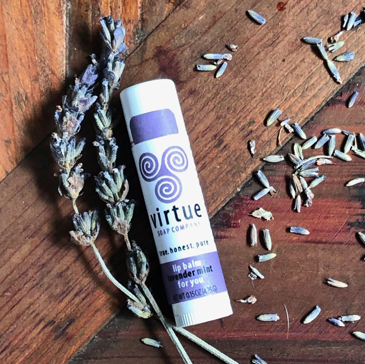 A 0.15oz tube of lavender lip balm, showcasing its elegant design and natural ingredients, perfect for softening and hydrating lips.