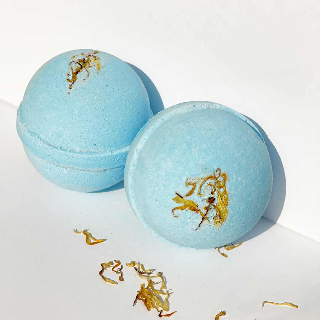 Young Citrus and Hemp Oil Bath Bomb, vibrant blue color, 8oz size, surrounded by citrus fruits and hemp leaves.