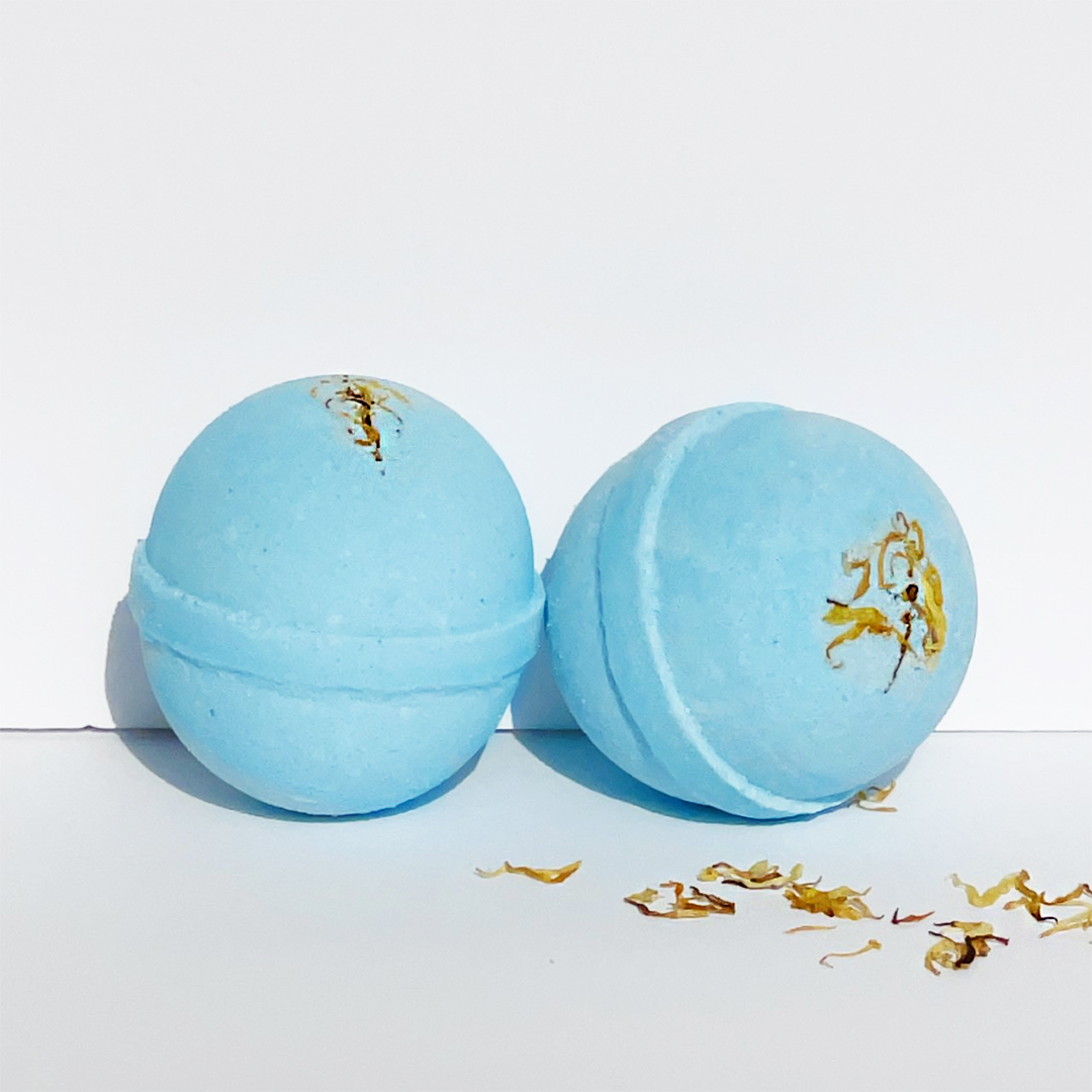 Young Citrus and Hemp Oil Bath Bomb, vibrant blue color, 8oz size, surrounded by citrus fruits and hemp leaves.