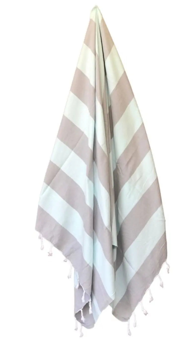 Zuma Turkish Towel featuring vibrant stripes and hand-twisted tassels, perfect for beach and pool use.