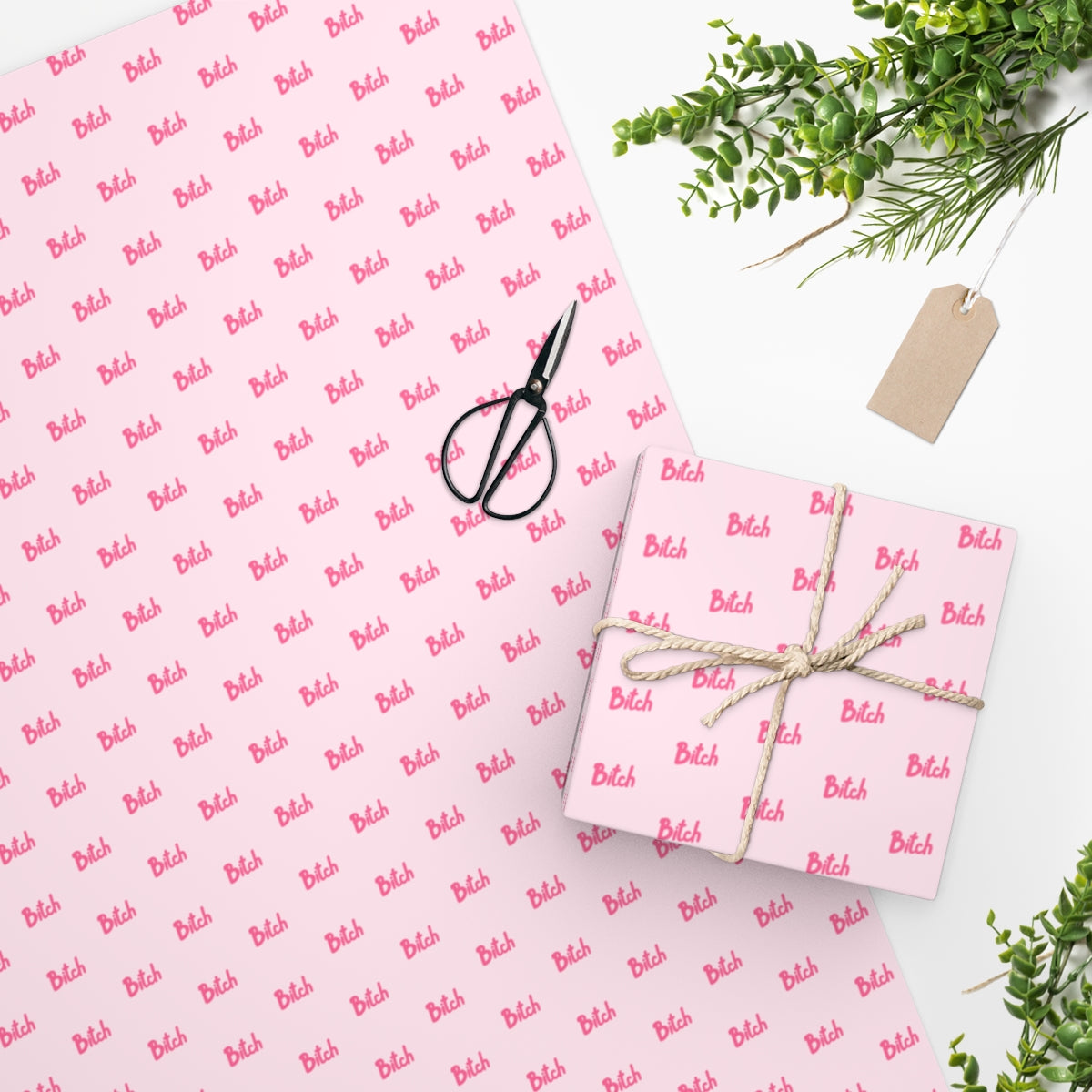 Vibrant pink Bitch Wrapping Paper featuring humorous design, rolled up and ready for gift wrapping.