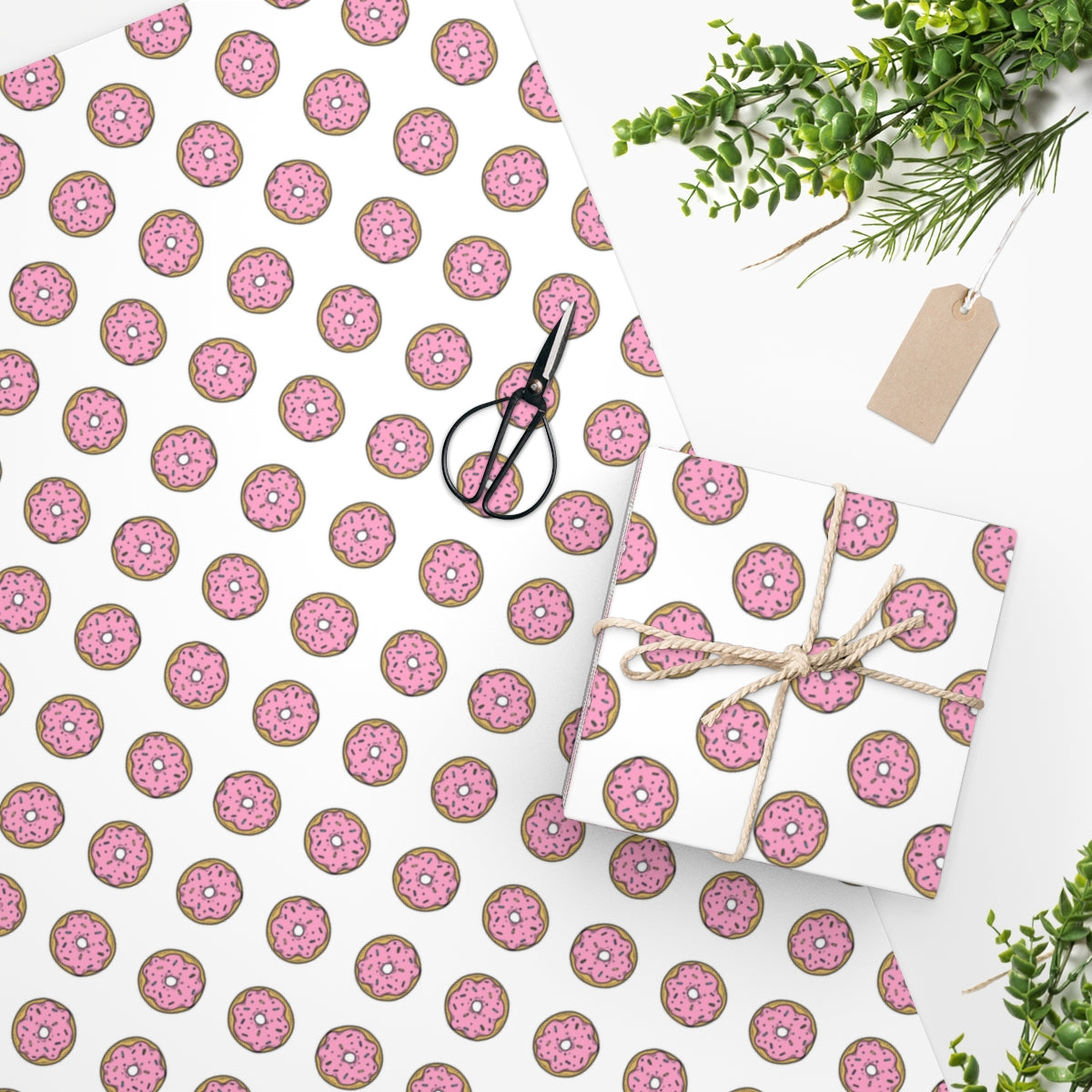 Colorful donut patterned wrapping paper rolled up, showcasing vibrant designs perfect for gift wrapping.