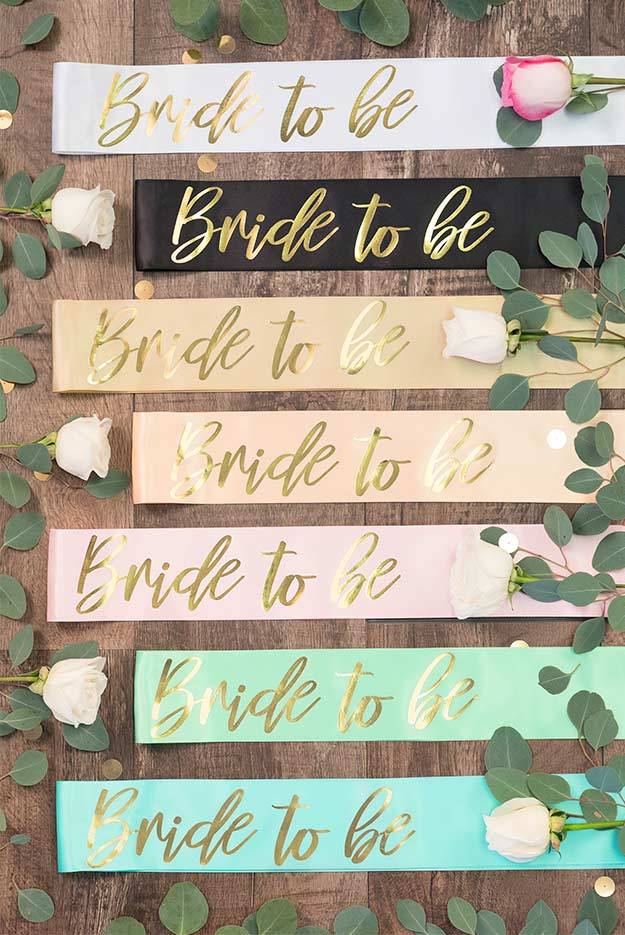 Bride To Be Gold Foil Sash in various colors, showcasing luxurious satin and shiny gold foil design.