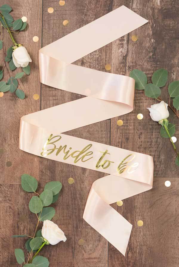 Bride To Be Gold Foil Sash in various colors, showcasing luxurious satin and shiny gold foil design.