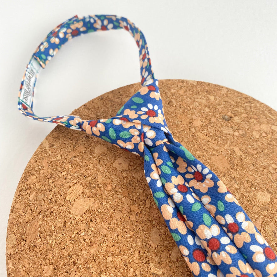 Colorful JUDE Floral Collection tie with abstract floral patterns, designed for children, featuring a pre-knotted design and Velcro fastening.