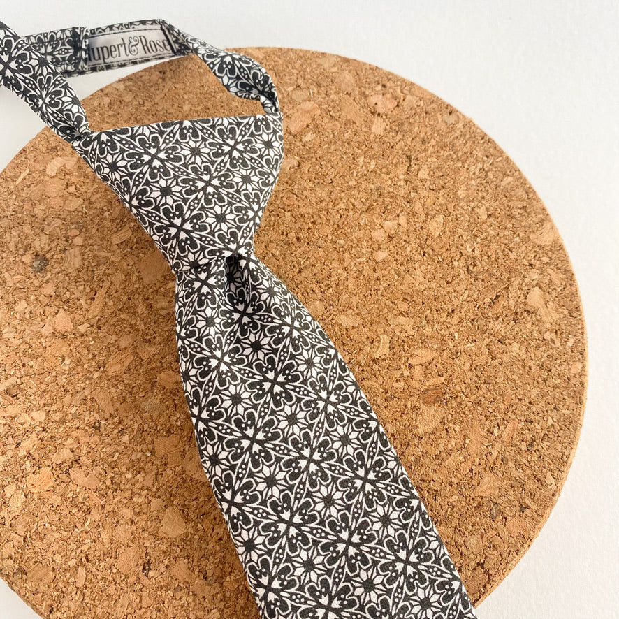 MAXIMUS Boys Velcro Tie featuring a black and white geometric design, handmade in England with a Velcro fastening for easy use.