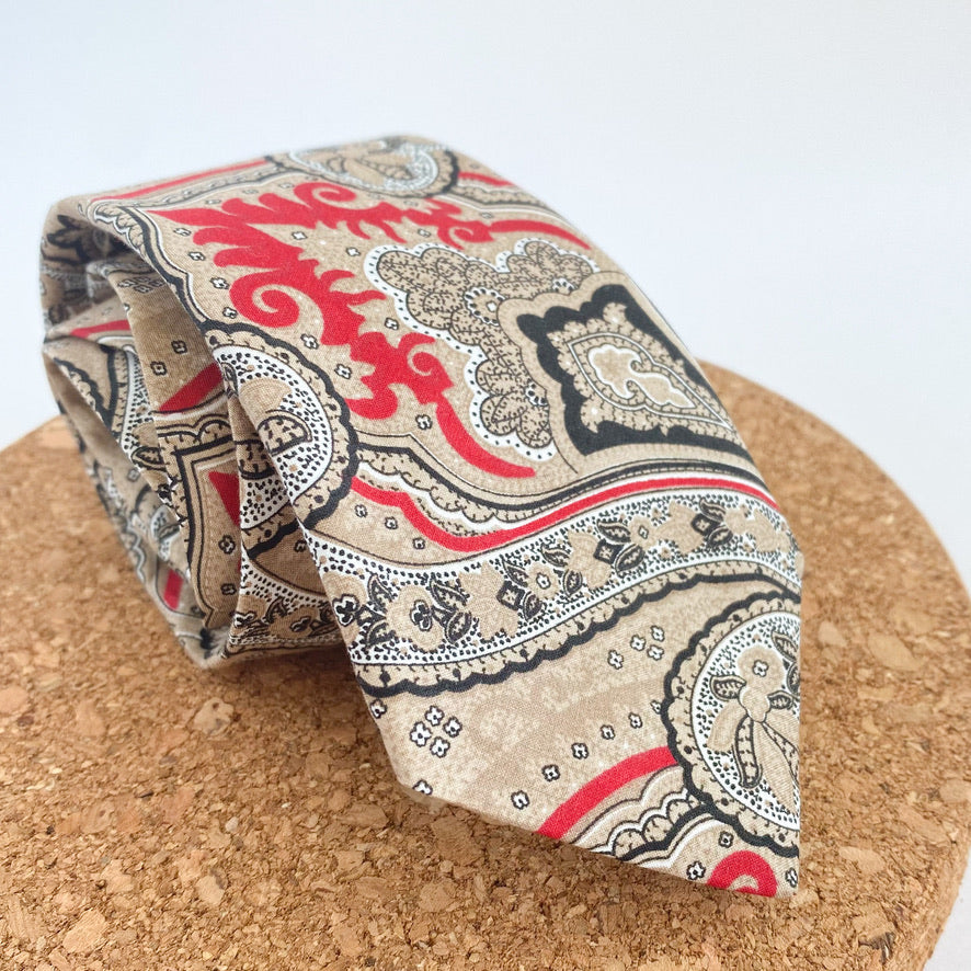 NICOLAS Mens Tie featuring a sophisticated paisley pattern in red and beige with black and white accents, handmade in England.