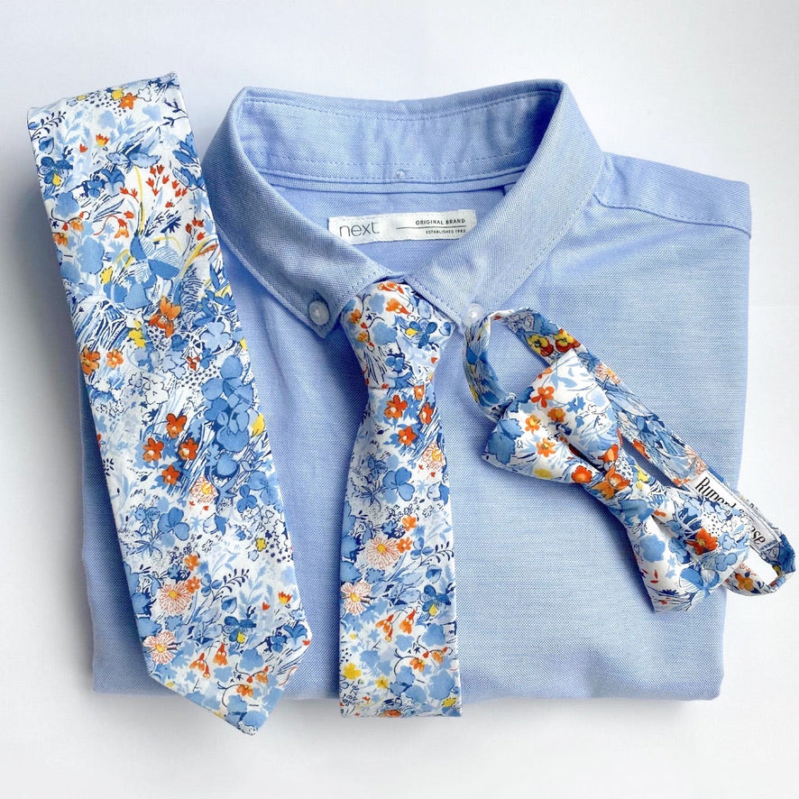 NOAH Floral Boys Velcro Ties featuring yellow and orange flowers on a blue background, perfect for summer events.