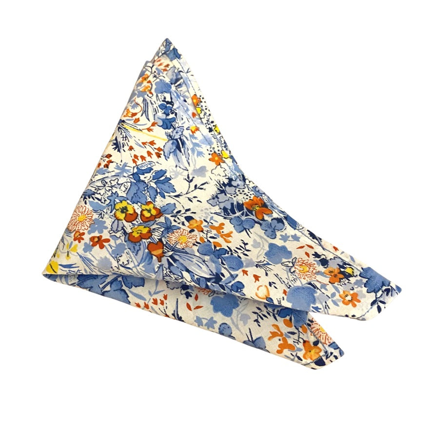 NOAH Pocket Square featuring vibrant yellow and orange flowers on a blue background, handmade in England.