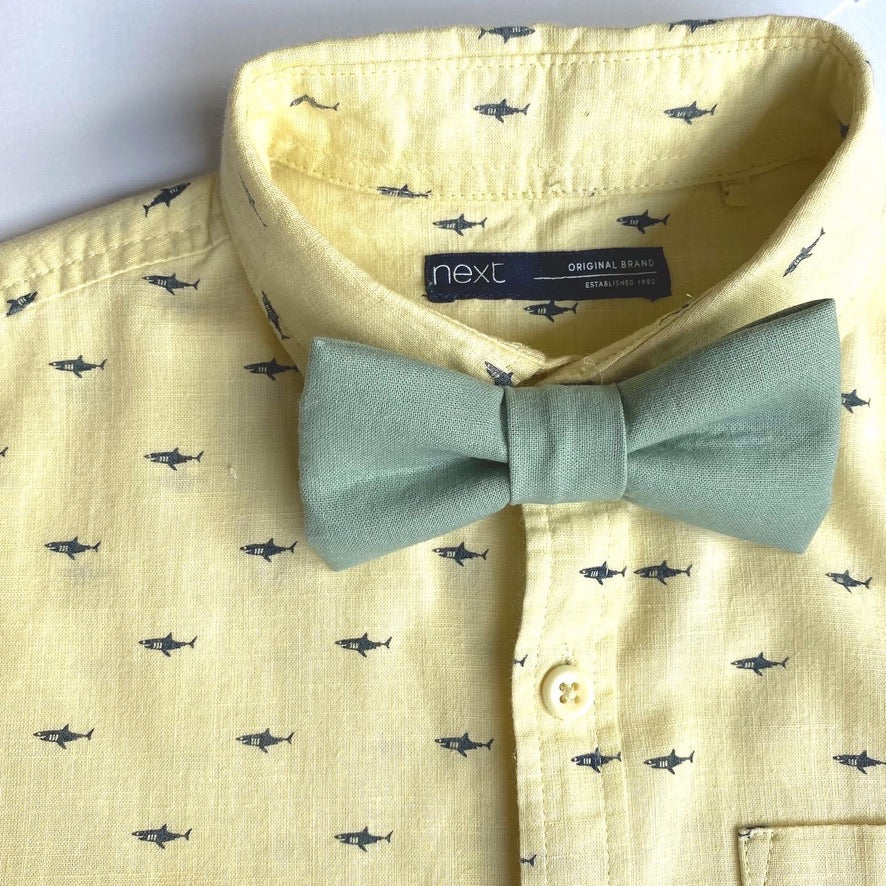 Sage green cotton boys bow tie, pre-tied with velcro fastening, perfect for weddings and special occasions.