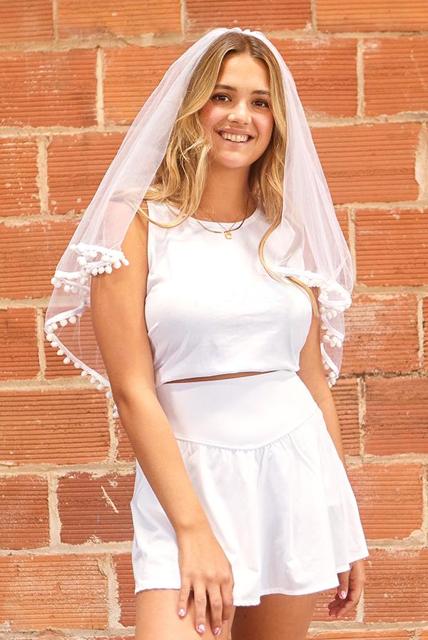 A beautiful White Pom Pom Bachelorette Party Veil featuring soft polyester fabric and playful pom-pom accents, secured with a versatile hair comb.