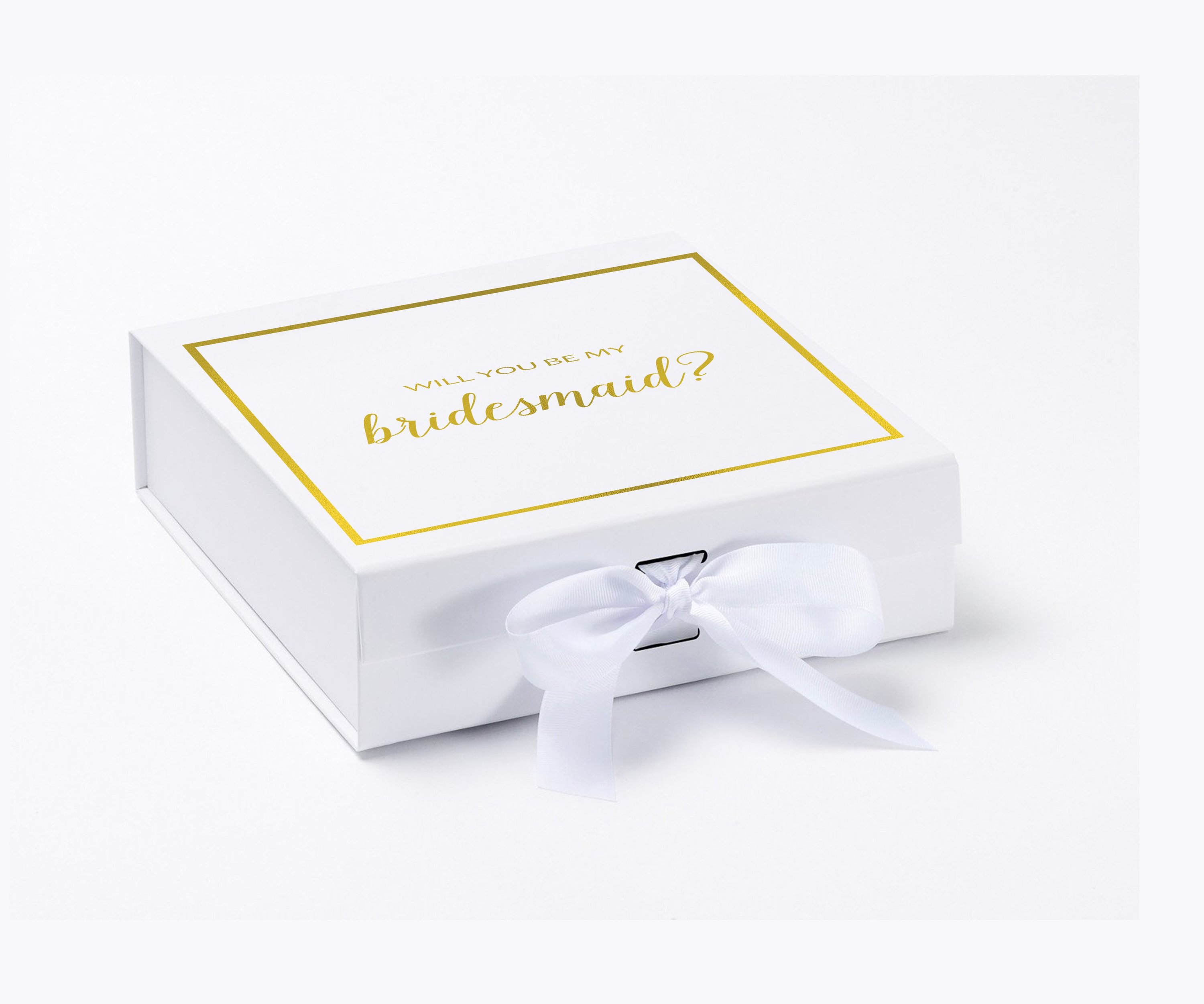 Elegant white gift box with gold metallic writing asking 'Will You Be My Bridesmaid', adorned with a black grosgrain ribbon.