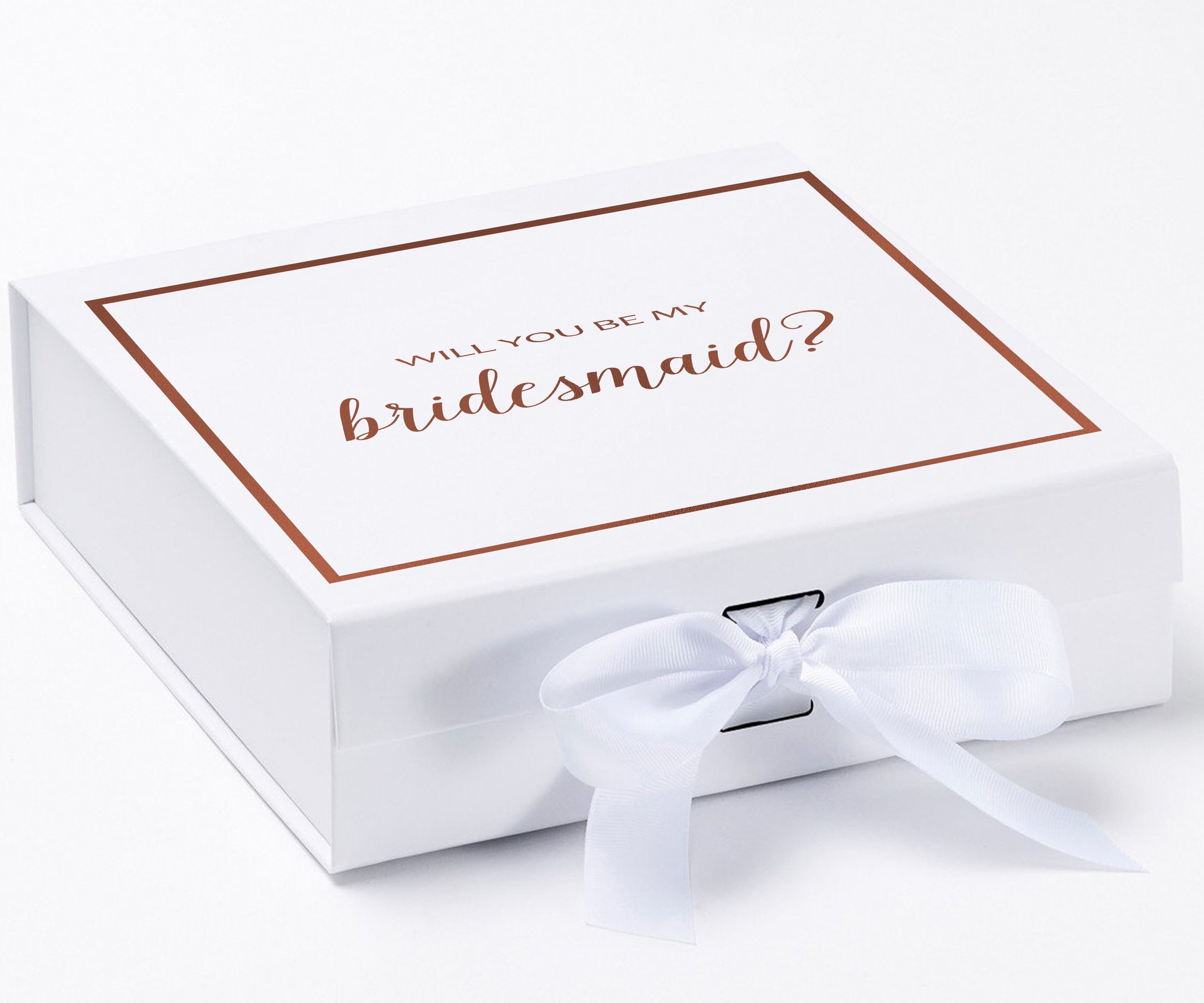 Elegant white gift box with gold metallic writing asking 'Will You Be My Bridesmaid', adorned with a black grosgrain ribbon.