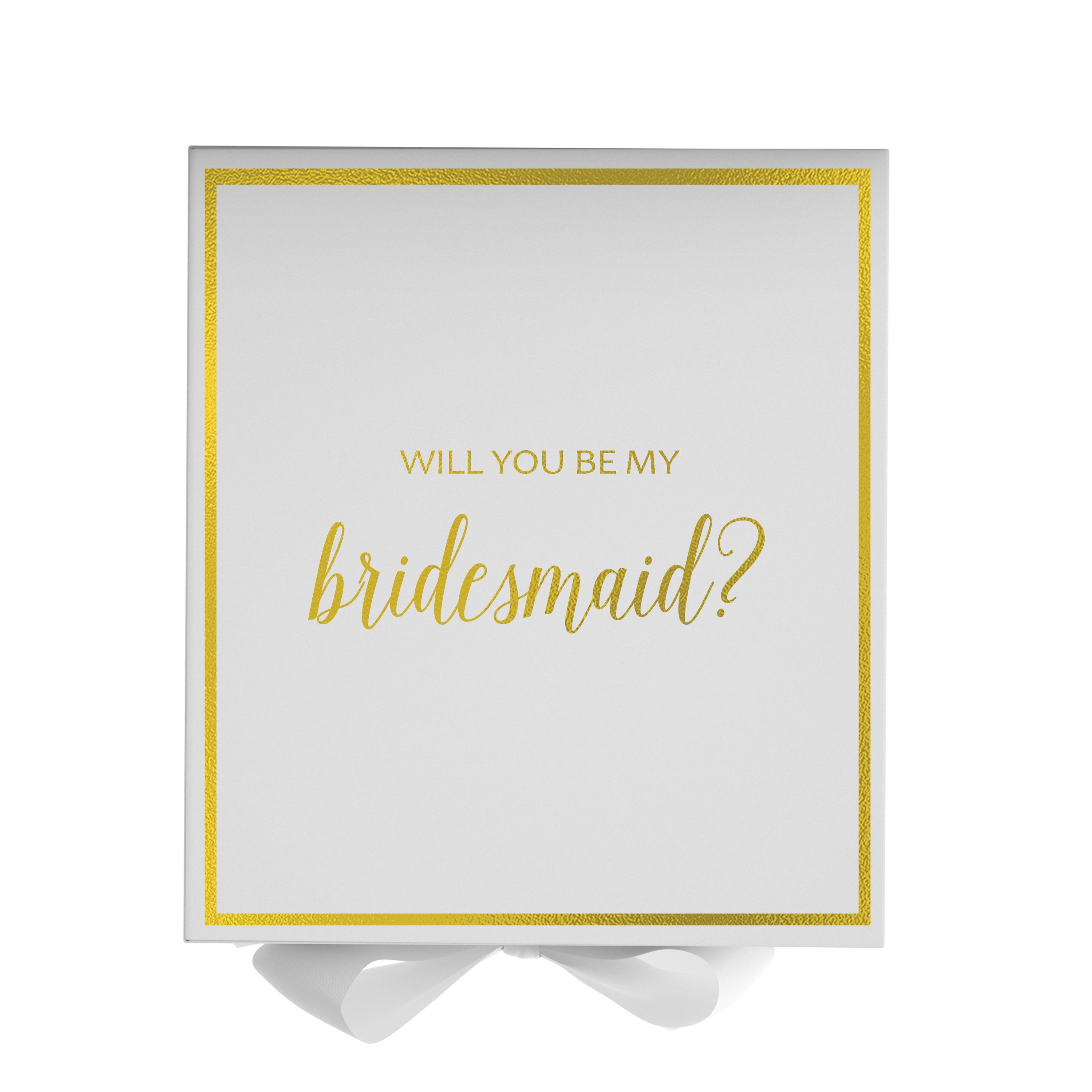 Elegant white gift box with gold metallic writing asking 'Will You Be My Bridesmaid', adorned with a black grosgrain ribbon.