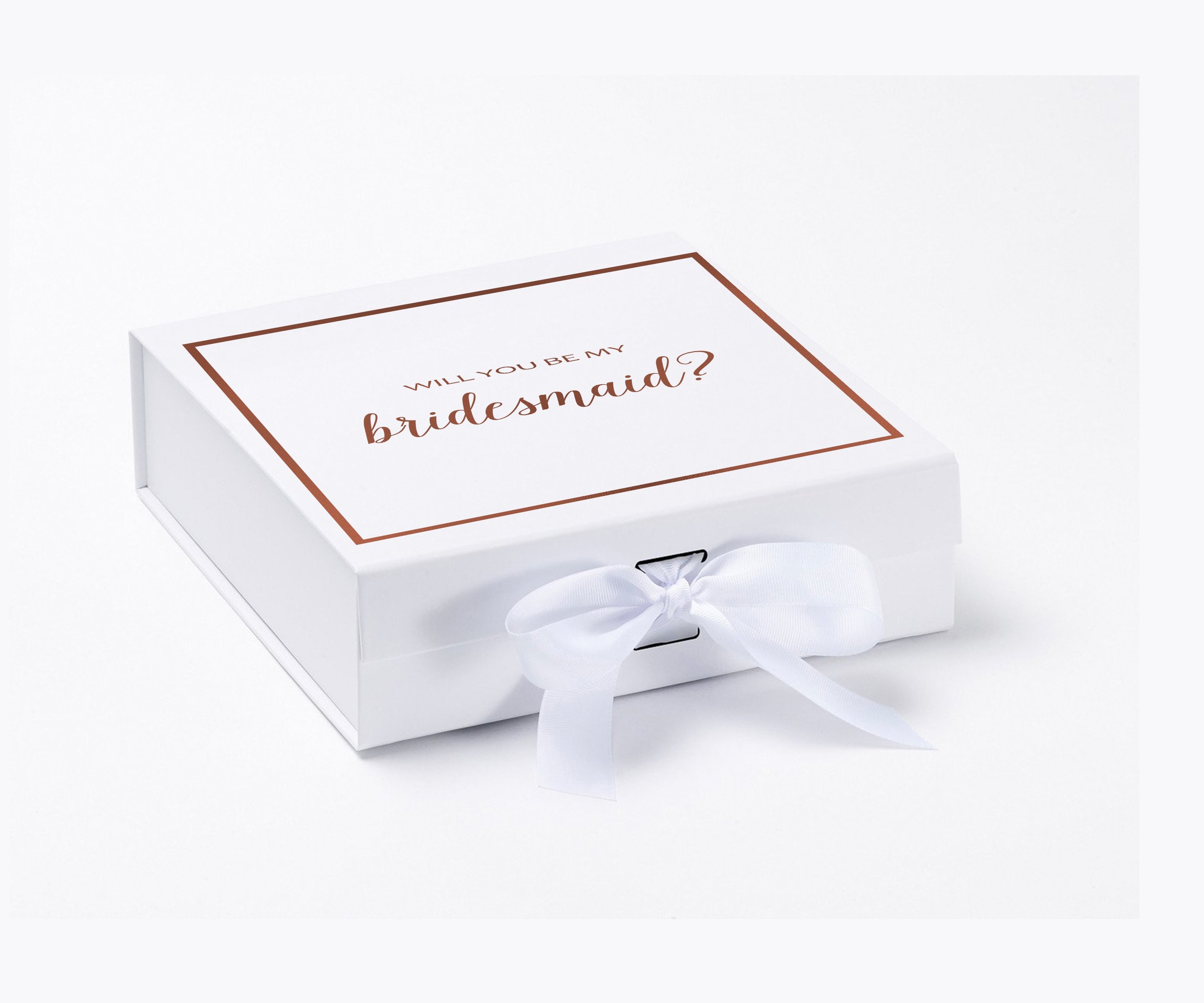 Elegant white gift box with gold metallic writing asking 'Will You Be My Bridesmaid', adorned with a black grosgrain ribbon.