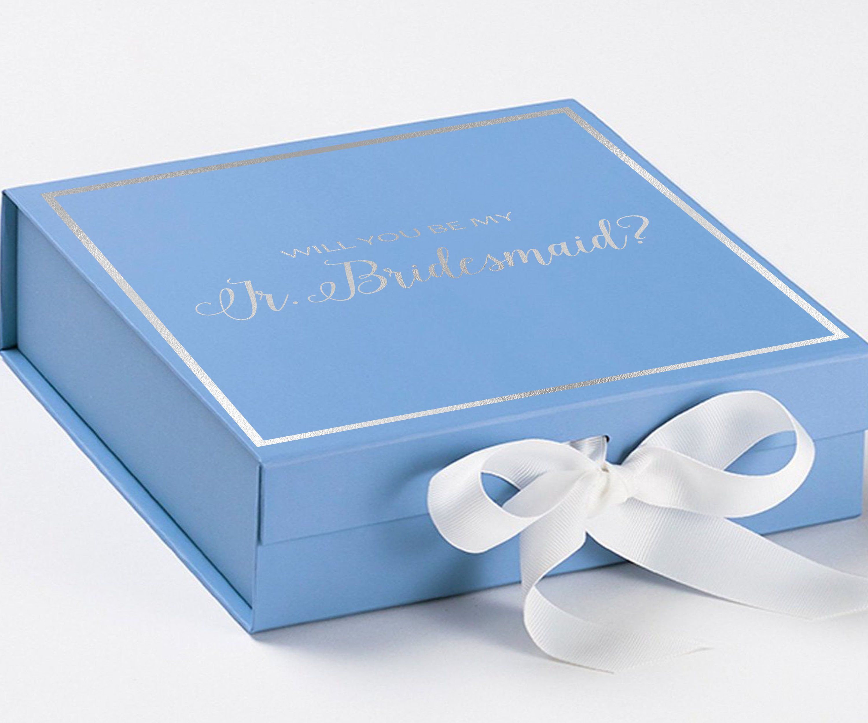 Light blue proposal box for junior bridesmaid with white bow and metallic writing on the lid, showcasing its elegant design.