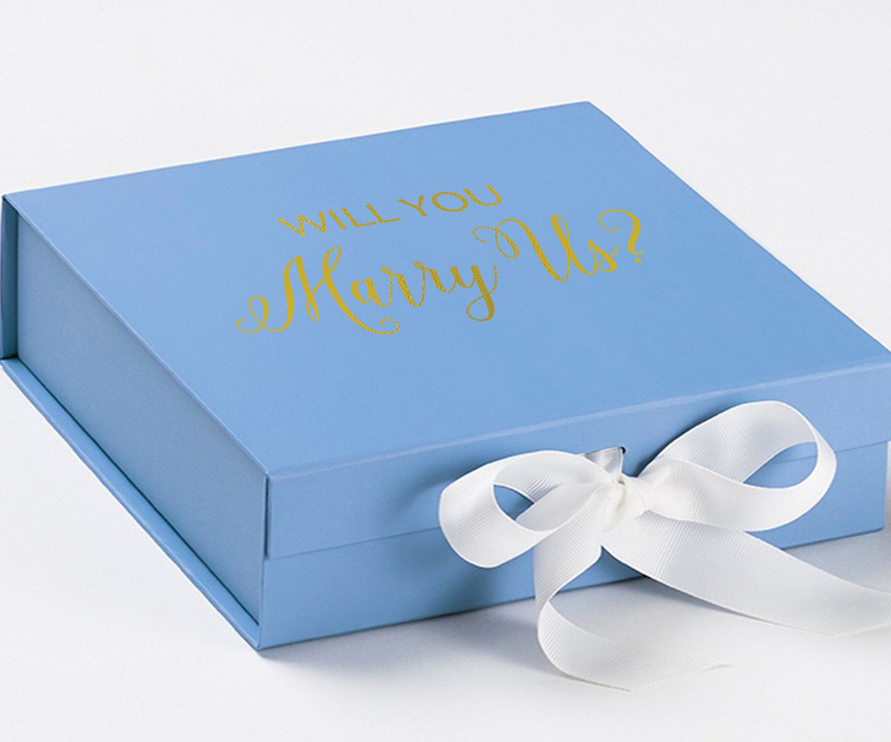 Light blue proposal box with white bow and metallic writing, perfect for engagement gifts.