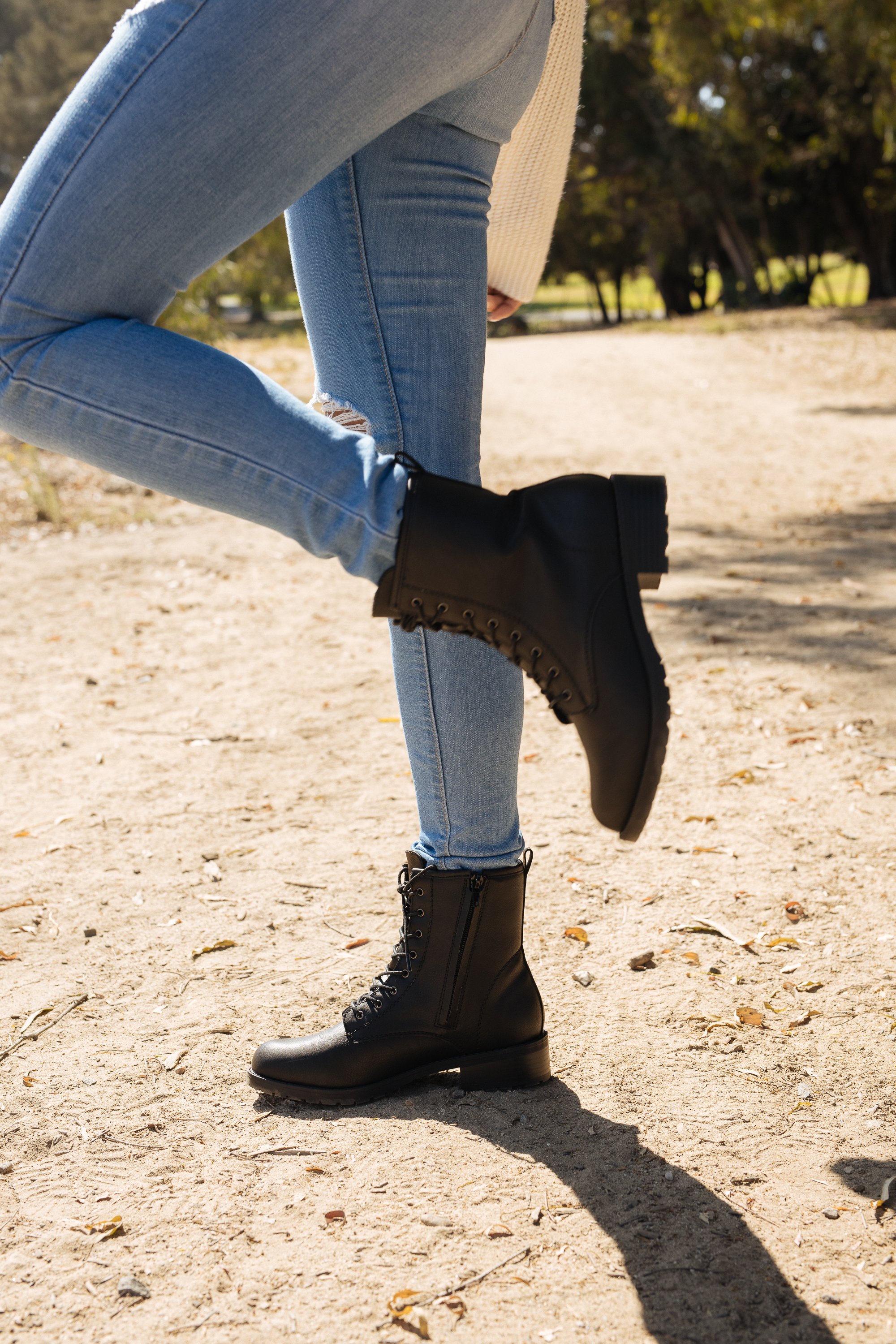 Stylish Women's Black Combat Boots with zipper closure and lace-up design, featuring a padded insole and grip sole for comfort and stability.