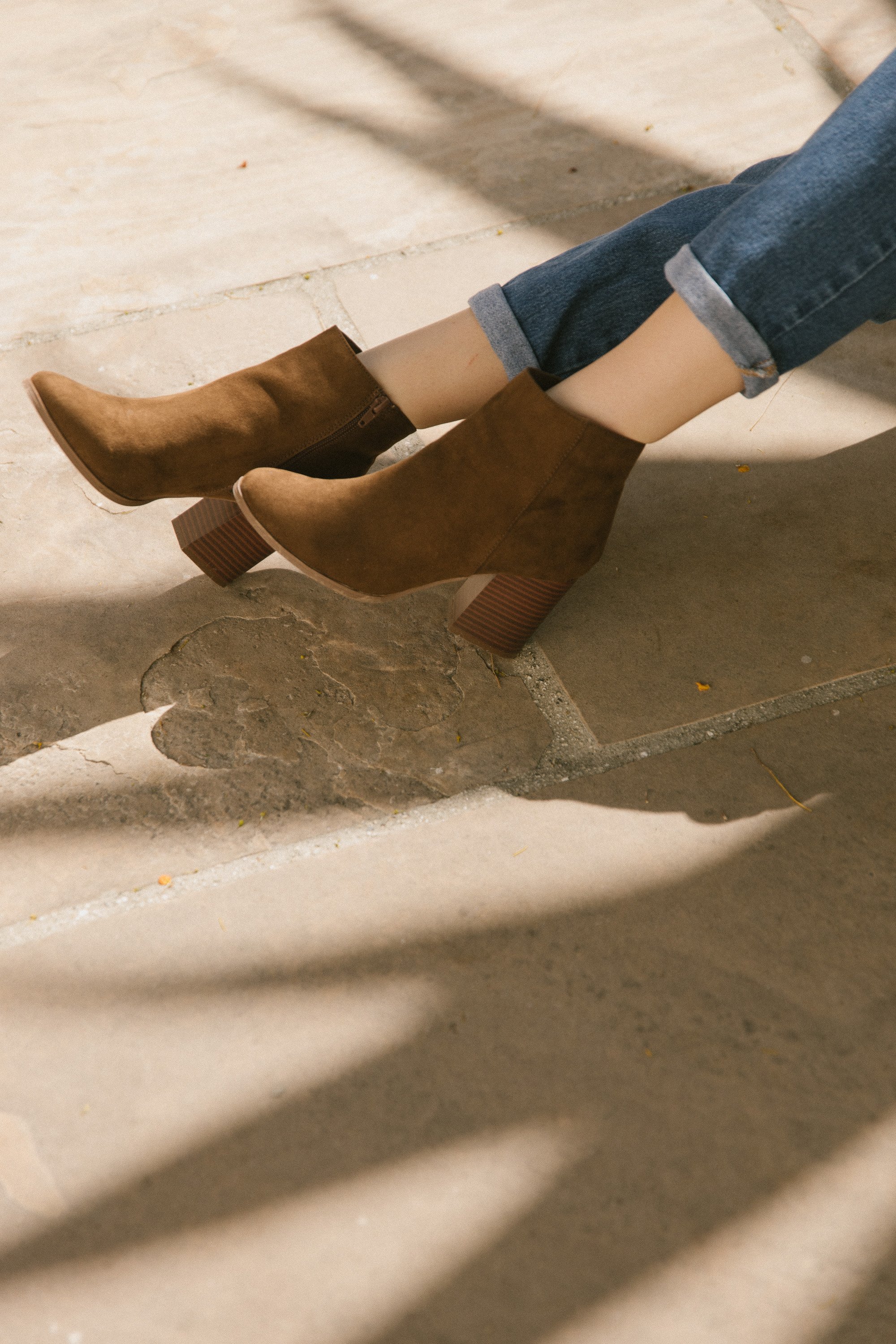 A pair of Women's Malibu Boots in brown featuring a stacked heel, almond toe, and side zip closure, perfect for stylish outings.