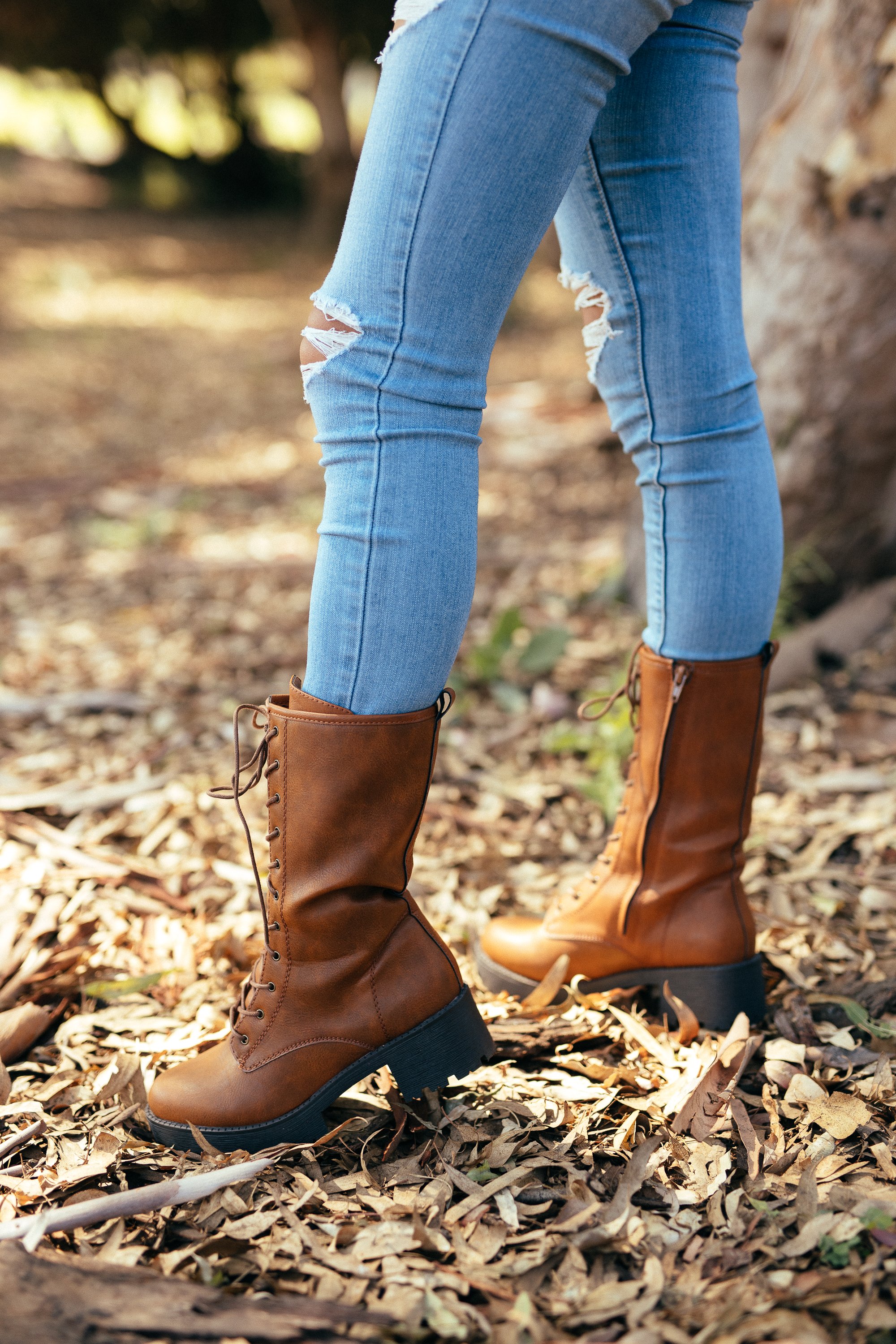 A pair of stylish Women's Private Boots in camel color, featuring a round toe, lace-up vamp, inner zip closure, and durable lug sole, perfect for any outfit.